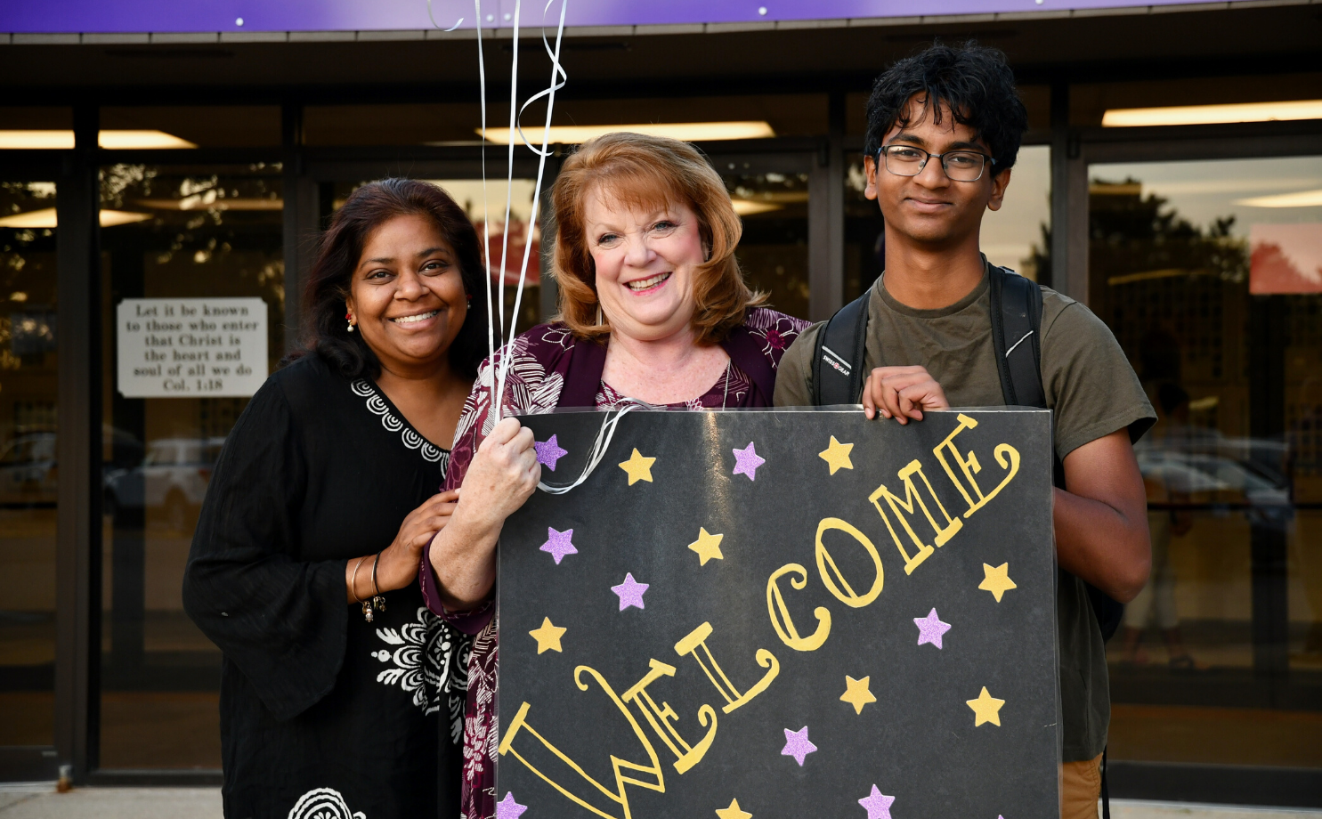 Plymouth Christian Academy Staff Members Holding Welcome Sign | How To Find The Right Private School | Admissions