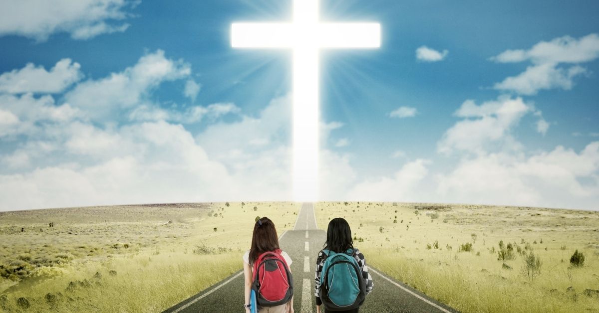 Girls With Backpacks Walking Down A Road Towards A Cross | Christian Schools In Michigan